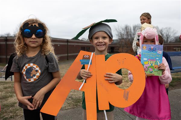 student in big orange costume